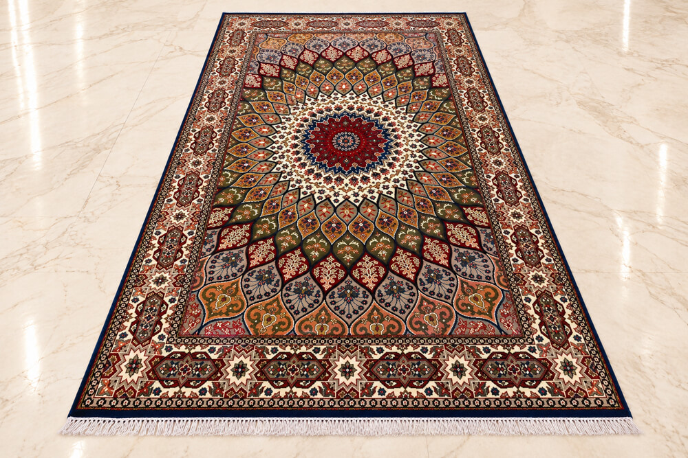 Royal Olive Shahzaneen wool-silk rug with a blue background, measuring 6 x 4 feet.